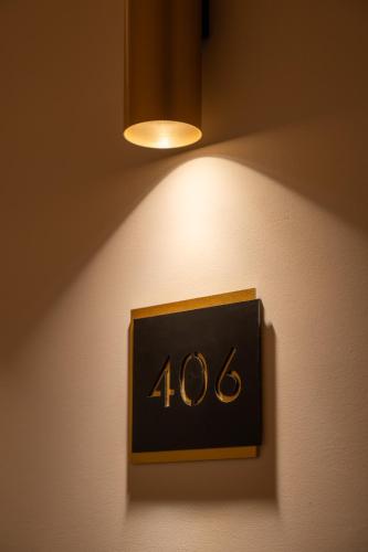 a clock on a wall with a light on it at Gallia Palace Hotel - Relais & Châteaux in Punta Ala