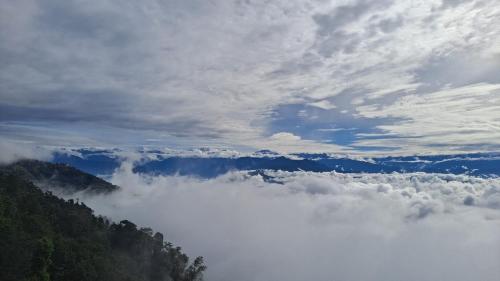 a view of a valley of clouds in the mountains at Tamang Culture Homestay in Nagarkot