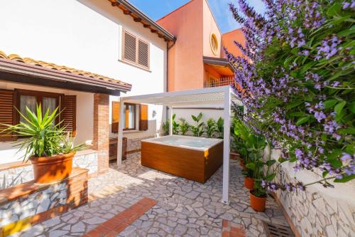 a garden with a hot tub in a backyard at Taormina Sea View Apartment in Taormina