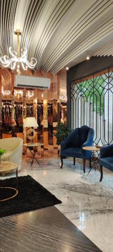 a large room with furniture and stained glass windows at The Belmorris in Multan