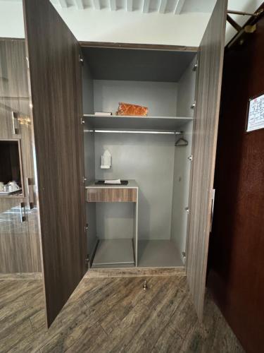 a walkin closet with ajar door with ajar door at The Belmorris in Multan