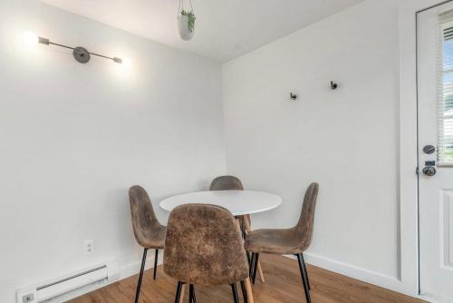 a white dining room with a white table and chairs at Tidal House #1 in Ocean Shores
