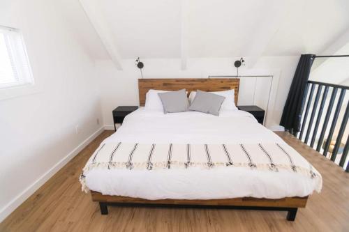 a bedroom with a large white bed with two pillows at Tidal House #1 in Ocean Shores