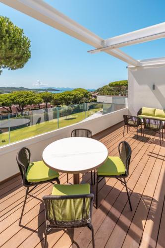 a patio with a table and chairs on a balcony at Gallia Palace Hotel - Relais & Châteaux in Punta Ala
