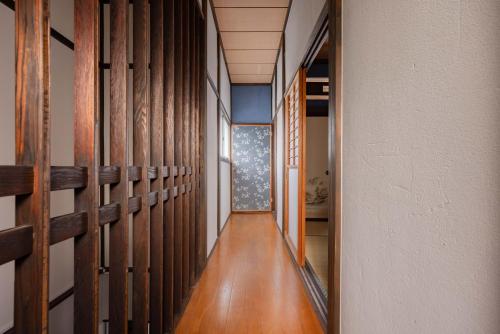 a hallway with wood paneled walls and a wooden floor at Macchiato SHONAN-Vacation Stay- in Hiratsuka