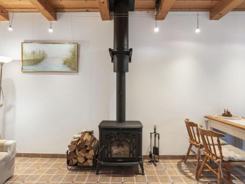 a wood stove in a living room with a table at Holiday Home Parkany 2 by Interhome in Bechyně