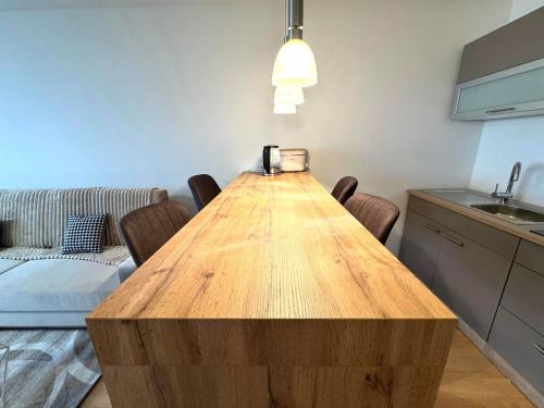 a kitchen with a wooden table in a room at NaturTraum Kniebis in Freudenstadt