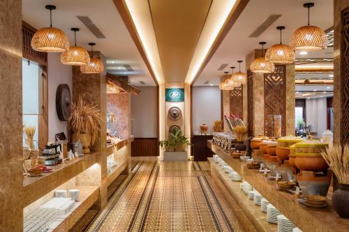 a store with a long aisle with pots and bowls at The Saga Hotel Hoi An in Hoi An