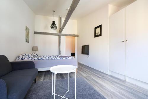 a bedroom with a bed and a couch and a table at Worker & families Dream Apartment in the heart of Gothenburg in Gothenburg