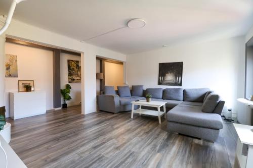 a living room with a couch and a table at Worker & families Dream Apartment in the heart of Gothenburg in Gothenburg