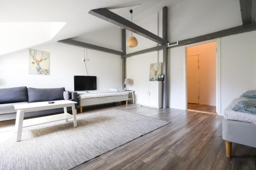 a living room with a couch and a table at Worker & families Dream Apartment in the heart of Gothenburg in Gothenburg