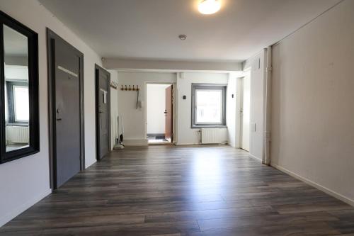 an empty hallway with white walls and wooden floors at Worker & families Dream Apartment in the heart of Gothenburg in Gothenburg