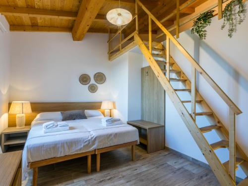 a bedroom with a bed and a staircase at Holiday Home Da Lisa by Interhome in Fiorino