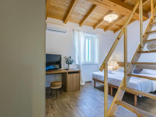 a bedroom with a bunk bed and a desk with a computer at Holiday Home Da Lisa by Interhome in Fiorino