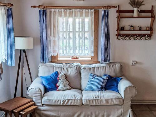 a living room with a couch and a window at Chalet Studenec by Interhome in Studenec