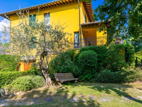 a yellow house with a bench in front of it at Holiday Home Villa Silvana by Interhome in Marcialla