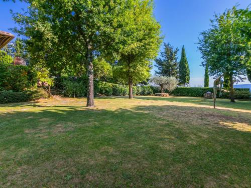 a park with a tree in the middle of a field at Holiday Home Villa Silvana by Interhome in Marcialla