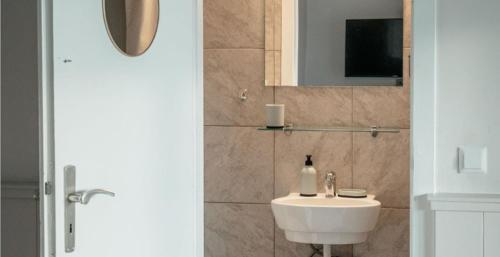 a bathroom with a sink and a mirror at Strandkoje - Landhaus in Neustadt in Holstein