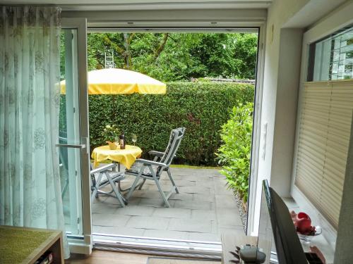 a patio with a table and an umbrella at Apartment Seestraße 60 by Interhome in Döbriach