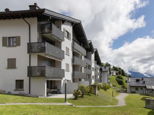 an apartment building with balconies and a lawn at Apartment La Siala Apt-30 by Interhome in Falera