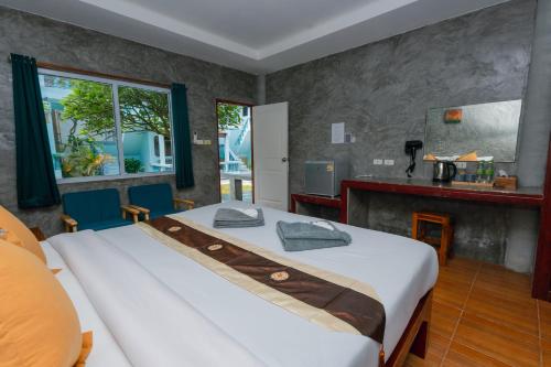 a bedroom with a large bed and a fireplace at Charung by The Sea in Haad Rin