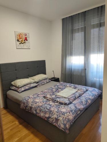 a bedroom with a bed and a window at Kastel in Banja Luka