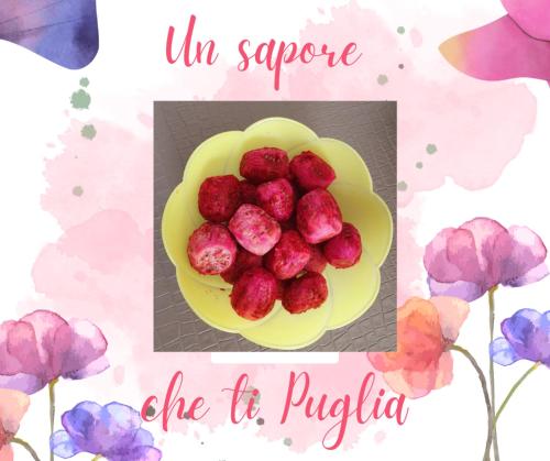 a bowl of raspberries on a plate next to flowers at L'Acquaviva in Bisceglie