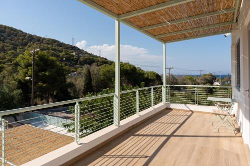 a balcony with a view of a mountain at AK-Green Villa near Athens Airport in Vravrona