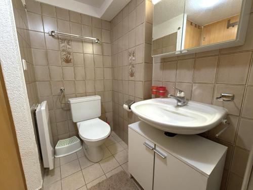 a small bathroom with a sink and a toilet at Chalet-Etage Mitten im Dorf in Leukerbad