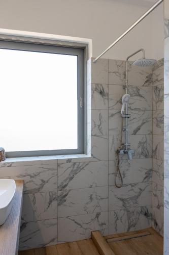 a bathroom with a shower and a sink at AK-Green Villa near Athens Airport in Vravrona