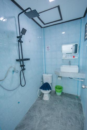 a bathroom with a shower and a toilet and a sink at Charung by The Sea in Haad Rin