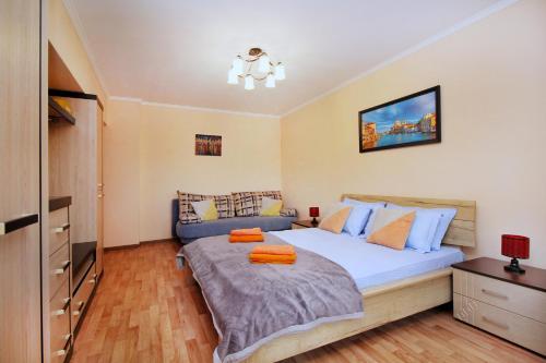 a bedroom with a large bed and a dresser at Меркур возле Аэропорта in Almaty
