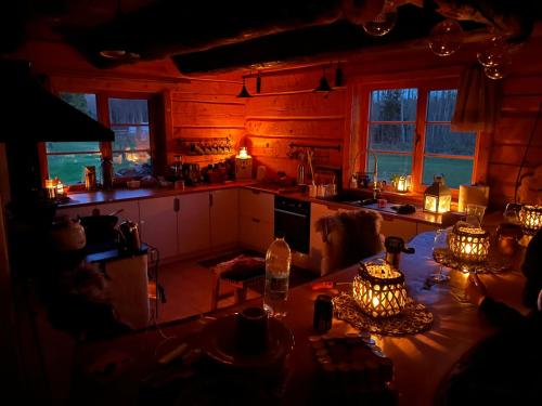 a kitchen with a table in the middle of a room at Näkimadala in Mereäärse