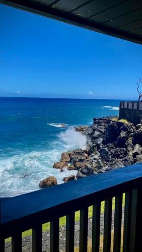a view of the ocean from a balcony at Hôtel Les Embruns Du Baril in Basse Vallée