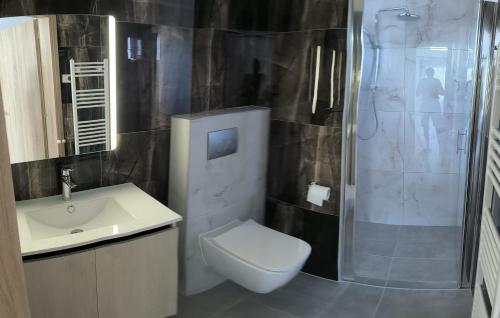 a bathroom with a toilet and a sink and a shower at Garden and Sea in Nikiti