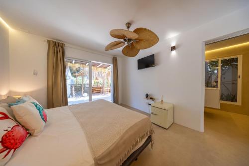 a bedroom with a bed and a ceiling fan at Villa Clara Ibiza in Santa Eularia des Riu