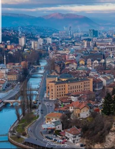 a view of a city with a river and buildings at Apartman Zlata - free parking in Sarajevo