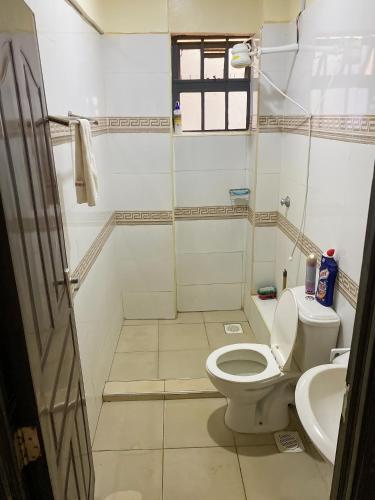 a bathroom with a toilet and a sink at Executive 1 bedroom house in Nairobi