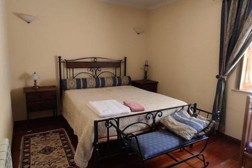 a bedroom with a bed and a chair and a window at 2Br Serra da Estrela Escape-Cheese & Wine Parking in Celorico da Beira