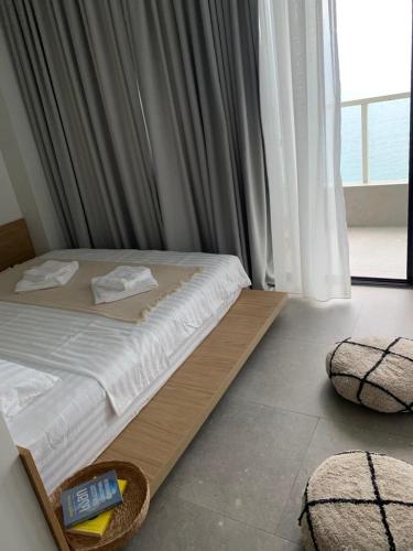 a bedroom with a bed with a sign on it at Bamboo Beach Tsikhisdziri! Enjoy your stay! in Tsikhisdziri