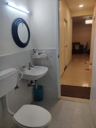 a bathroom with a toilet and a sink and a mirror at not applicable! in Kaikalapettai