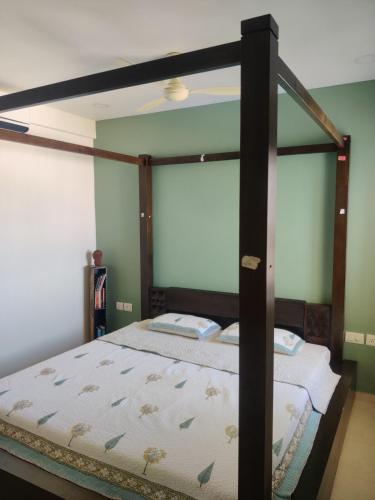 a canopy bed in a bedroom with green walls at not applicable! in Kaikalapettai