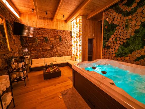 a jacuzzi tub in the middle of a room at Bányahegyi erdei nyugalom és wellness in Tardos