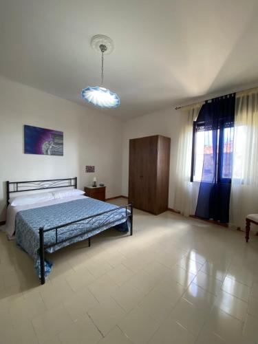 a large bedroom with a bed and a window at La Contessa dimora storica in Giungano