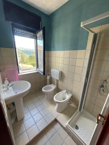 a bathroom with a sink and a toilet and a shower at La Contessa dimora storica in Giungano
