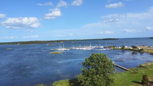a group of boats docked in a large body of water at Lilla Lycka Timmernabben in Timmernabben