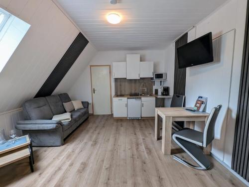 a living room with a couch and a table at Pensions- & Monteuerzimmer Apartment 5 in Twist