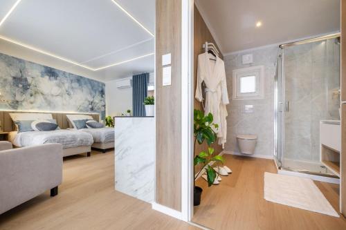 a bedroom with a bed and a bathroom with a shower at Studios an der Alten Post in Maxhütte-Haidhof