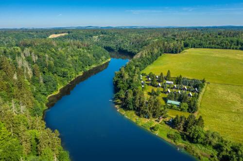 an aerial view of a river with a group of houses at Baribouda - Chaty Na Rybárně in Louka