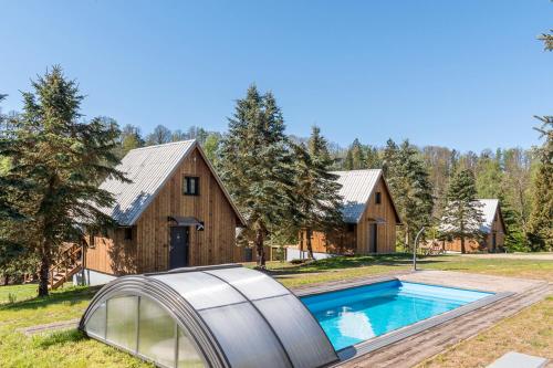 an exterior view of a house with a swimming pool at Baribouda - Chaty Na Rybárně in Louka